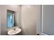 Powder room featuring a pedestal sink with a modern mirror and a white door at 1343 Lassen St, Haines City, FL 33844