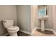 Powder room featuring a toilet and pedestal sink with a modern mirror at 1343 Lassen St, Haines City, FL 33844