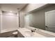 Bright bathroom featuring a large mirror, a tub with shower, and a white vanity at 1343 Lassen St, Haines City, FL 33844