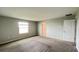 Spacious bedroom with plush carpeting, a bright window, and a closet at 1343 Lassen St, Haines City, FL 33844