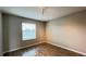 Bedroom featuring wood-look tile flooring, light gray walls, and a window for natural light at 1343 Lassen St, Haines City, FL 33844