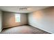 A comfortable bedroom with neutral carpet, a window offering natural light, and ample wall space at 1343 Lassen St, Haines City, FL 33844