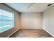 Bedroom featuring wood-look tile flooring, light gray walls, and a window with blinds for natural light at 1343 Lassen St, Haines City, FL 33844