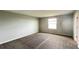 Bedroom with a large window, plush carpet, and freshly painted walls at 1343 Lassen St, Haines City, FL 33844