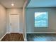 Welcoming entryway featuring wood-look tile flooring, a white front door, and a large window at 1343 Lassen St, Haines City, FL 33844