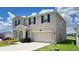 Two-story home with a two car garage, arched entry and manicured landscaping at 1343 Lassen St, Haines City, FL 33844
