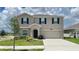 Charming two-story home with a well-maintained lawn, two car garage and black window shutters at 1343 Lassen St, Haines City, FL 33844