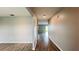 Hallway featuring wood-look tile flooring and neutral walls leading to rooms at the end of the corridor at 1343 Lassen St, Haines City, FL 33844
