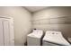 Laundry area equipped with a washer, dryer, and overhead storage space at 1343 Lassen St, Haines City, FL 33844