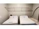 Practical laundry area includes a washer, dryer, and convenient wire shelving at 1343 Lassen St, Haines City, FL 33844