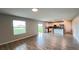 Open-concept living space with wood-look tile, seamlessly connecting to a modern kitchen at 1343 Lassen St, Haines City, FL 33844