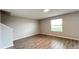Cozy living room featuring wood-look tile flooring, a window, and neutral wall color at 1343 Lassen St, Haines City, FL 33844