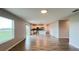 Bright and airy living space with wood-look tile and a view of the modern kitchen at 1343 Lassen St, Haines City, FL 33844