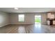 Bright living room features wood-look tile flooring and sliding glass doors to the backyard at 1343 Lassen St, Haines City, FL 33844