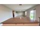 Open-concept space showcasing the staircase, living room and dining area from kitchen island at 1343 Lassen St, Haines City, FL 33844