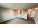 Open loft area with soft carpeting and a view into the hallway, offering a versatile living space at 1343 Lassen St, Haines City, FL 33844