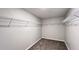 Walk-in closet features neutral walls and carpet with installed wire shelving at 1343 Lassen St, Haines City, FL 33844