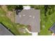 Detailed aerial view of the property's roof, lush backyard, and close proximity to neighboring homes and green landscape at 1405 Ashbury Ct, Lakeland, FL 33809