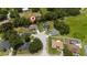 Aerial view of homes in a cul-de-sac surrounded by mature trees and lush greenery in a quiet neighborhood at 1405 Ashbury Ct, Lakeland, FL 33809