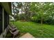 Lush backyard featuring mature trees and a seating area, ideal for outdoor relaxation at 1405 Ashbury Ct, Lakeland, FL 33809