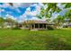 Large backyard showcasing lush greenery, mature trees, and a spacious lawn at 1405 Ashbury Ct, Lakeland, FL 33809