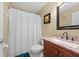 Bathroom with granite countertop, white shower curtain, and neutral wall color at 1405 Ashbury Ct, Lakeland, FL 33809