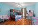 Bright bedroom with a wooden bunk bed, desk, and wood-look flooring at 1405 Ashbury Ct, Lakeland, FL 33809