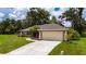 Charming single-story home featuring a spacious driveway, well-maintained lawn, and classic architectural design at 1405 Ashbury Ct, Lakeland, FL 33809
