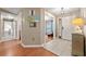 Foyer with tile flooring, a decorative front door, and view into the living room at 1405 Ashbury Ct, Lakeland, FL 33809