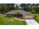 Charming single-story home with a well-manicured lawn and a two car garage at 1405 Ashbury Ct, Lakeland, FL 33809