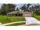 Charming single-story home with a well-manicured lawn and a two car garage at 1405 Ashbury Ct, Lakeland, FL 33809