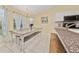Bright eat-in kitchen featuring an elegant chandelier and a spacious, tiled dining area with modern appliances at 1405 Ashbury Ct, Lakeland, FL 33809