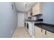 Functional laundry room with modern appliances, storage cabinets, and ample counter space at 1405 Ashbury Ct, Lakeland, FL 33809