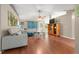 Inviting living room with hardwood floors, neutral paint, ceiling fan, and comfortable seating for relaxation and entertainment at 1405 Ashbury Ct, Lakeland, FL 33809