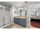 Well-lit bathroom featuring a shower, a double vanity with ample counter space, and access to the main bedroom at 1405 Ashbury Ct, Lakeland, FL 33809