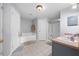 Bright bathroom with a soaking tub, a separate shower, double sinks, and neutral tile floors at 1405 Ashbury Ct, Lakeland, FL 33809