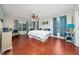 Spacious main bedroom with hardwood floors, large windows, and stylish blue curtains at 1405 Ashbury Ct, Lakeland, FL 33809