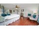Comfortable main bedroom featuring hardwood floors, a ceiling fan, and cozy seating area at 1405 Ashbury Ct, Lakeland, FL 33809