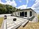 Enjoy the beautiful backyard with a patio, fire pit, and screened-in lanai for outdoor relaxation and entertainment at 144 Foxtail Loop, Davenport, FL 33837