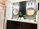 Contemporary bathroom featuring dual sinks, modern lighting, and a walk-in shower at 144 Foxtail Loop, Davenport, FL 33837