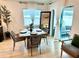 Cozy dining area with natural light, a modern table setting, and access to outdoor space at 144 Foxtail Loop, Davenport, FL 33837