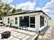 Backyard with outdoor seating, a patio, exterior access to sunroom, and a well maintained lawn at 144 Foxtail Loop, Davenport, FL 33837