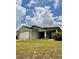 Charming single-story home with a well-manicured lawn and a two-car garage, showcasing inviting curb appeal at 144 Foxtail Loop, Davenport, FL 33837