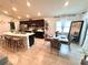 Open-concept kitchen and dining area with stylish pendant lights and modern appliances at 144 Foxtail Loop, Davenport, FL 33837