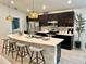 Modern kitchen featuring stainless steel appliances, a large island, and pendant lighting at 144 Foxtail Loop, Davenport, FL 33837