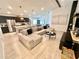 Open-concept living room featuring a modern kitchen, spacious seating area, and stylish decor, perfect for entertaining at 144 Foxtail Loop, Davenport, FL 33837