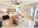 Comfortable bedroom featuring a tufted headboard, soft lighting, and neutral color palette at 144 Foxtail Loop, Davenport, FL 33837