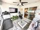 Inviting sunroom features workout equipment, modern furnishings, and sliding glass doors for seamless indoor-outdoor living at 144 Foxtail Loop, Davenport, FL 33837