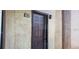 Unit 108 features a solid wood front door with a textured exterior wall and sconce lighting at 2002 Cascades Blvd # 108, Kissimmee, FL 34741