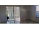 Living room with tiled floor, sliding glass doors to patio and a window at 2002 Cascades Blvd # 108, Kissimmee, FL 34741